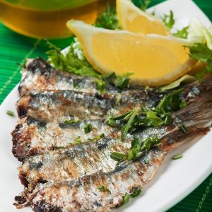 grilled sardine wish served with lemon and herbs shutterstock 140688478